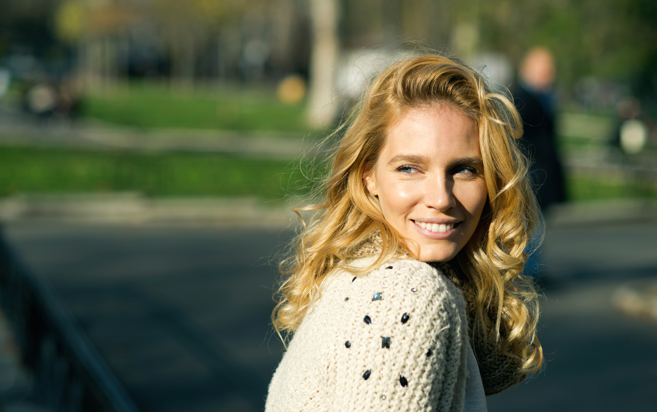 Attractive woman smiling and walking outside